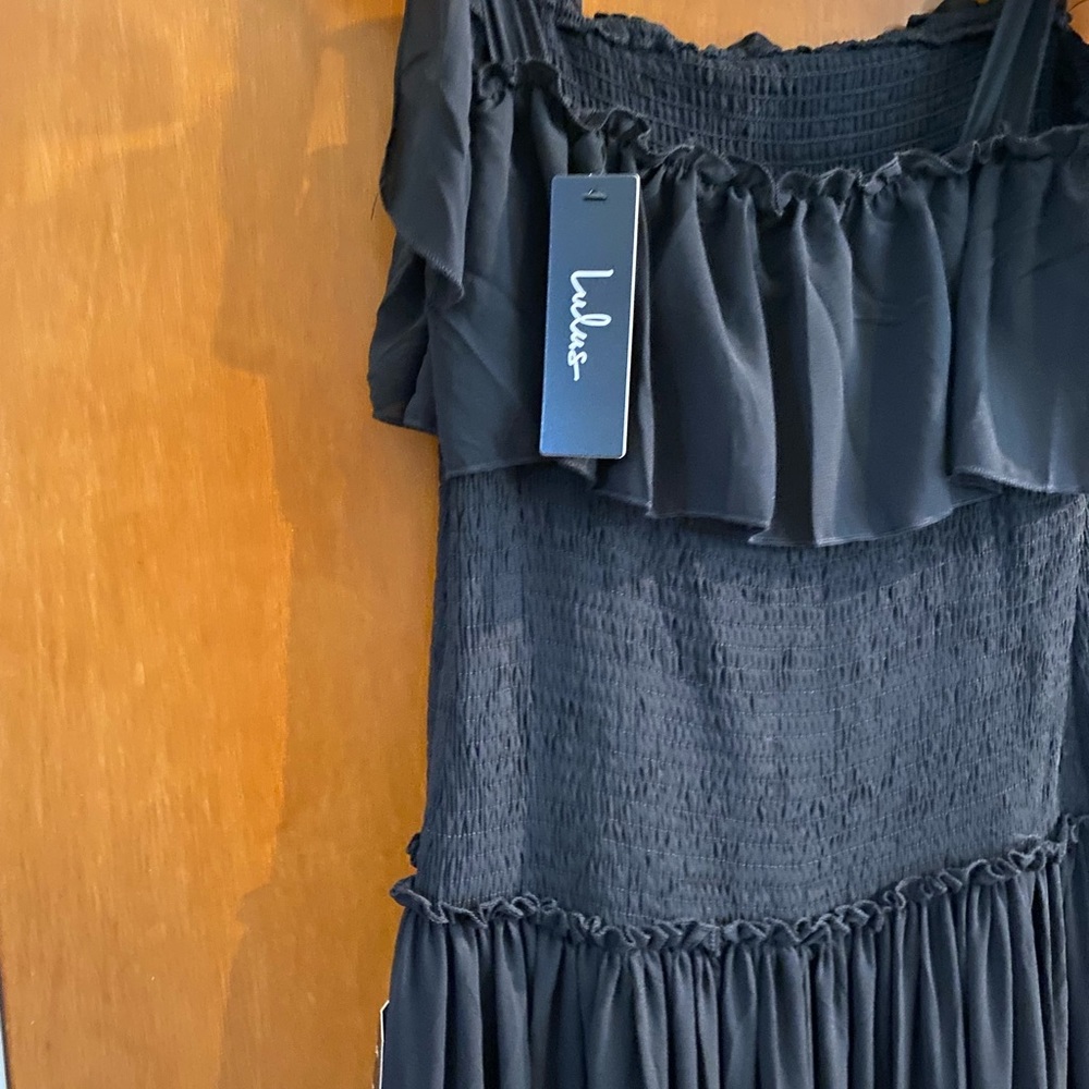 Maxi tiered black dress with tied details on the shoulders